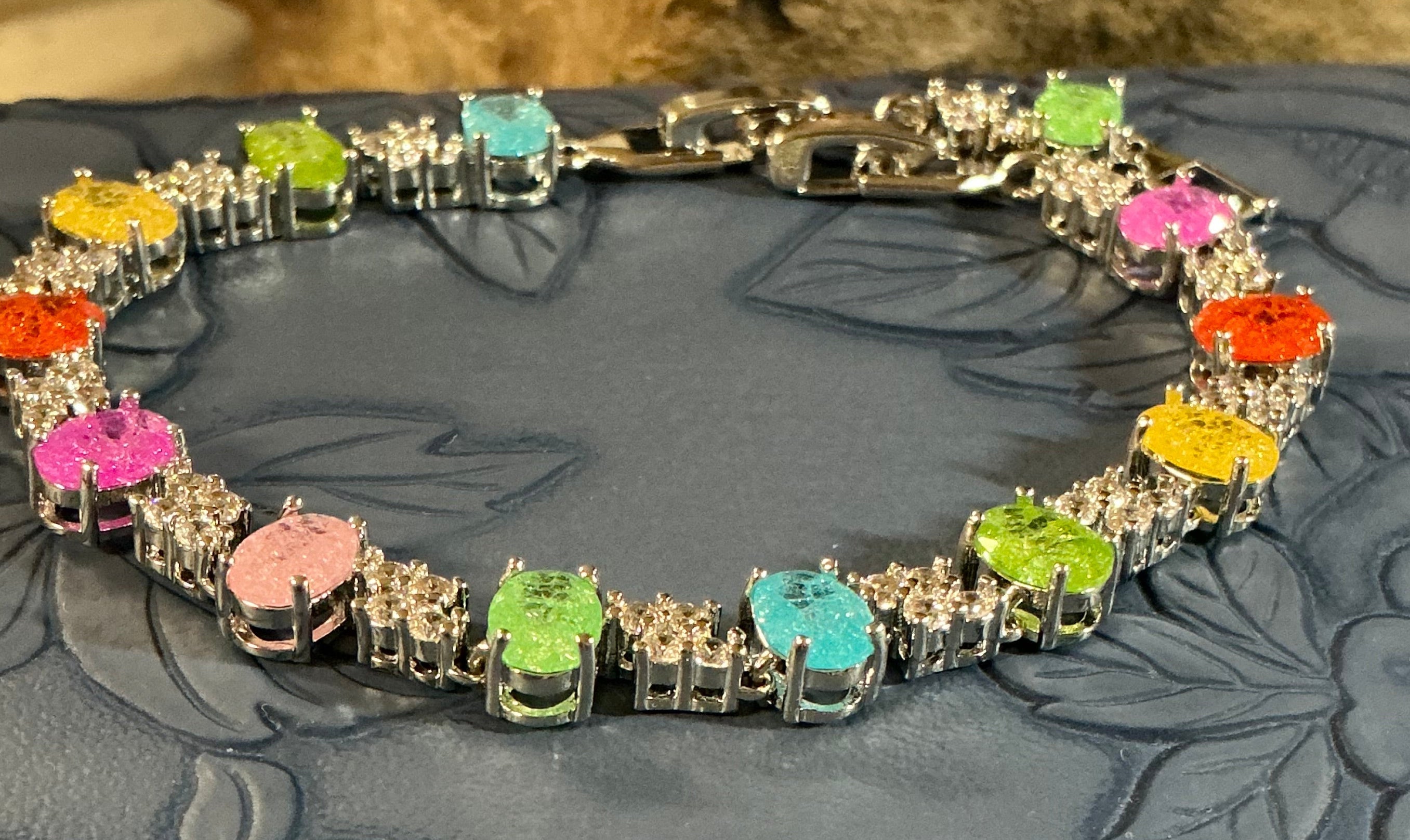 Oval Candy-colored translucent stones with sparkling shimmer throughout, accented by cubic zirconia stones.