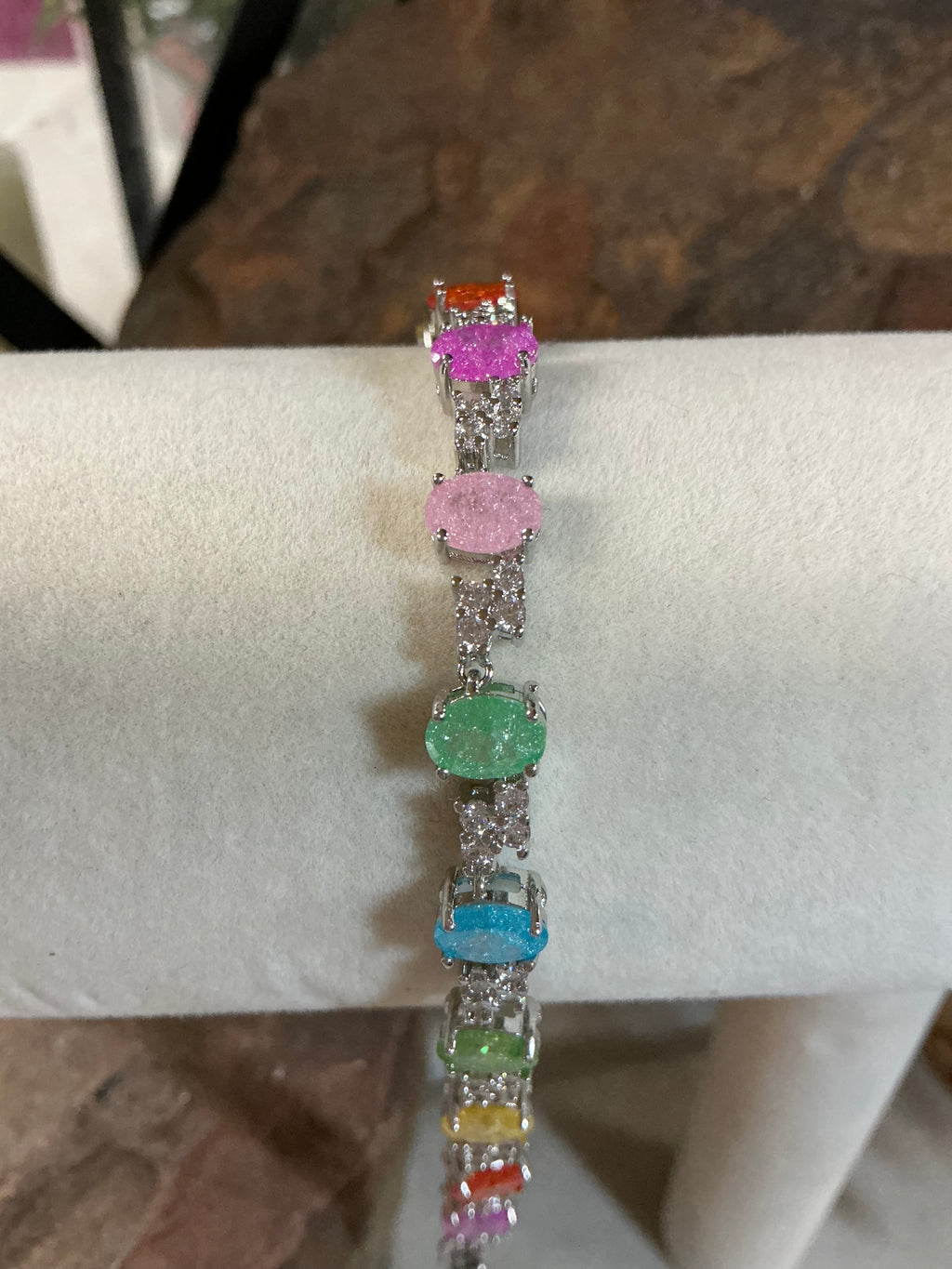 Oval Candy-colored translucent stones with sparkling shimmer throughout, accented by cubic zirconia stones.